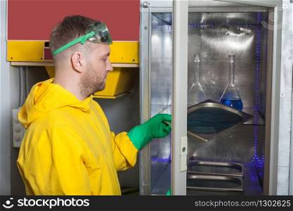 Man in protective suit working in the lab. Man cooking meth