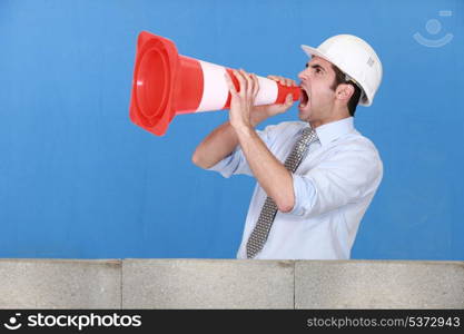 Man in safety hat screaming