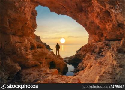 Man in sea grotto. Sea cave mainsail nature landsacpe.