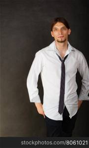 Man in shirt and tie.. Masculinity fashion concept. Man in shirt and tie. Young long haired male on dark background.