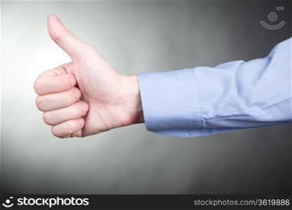 Man in shirt gesturing approval thumbs up sign