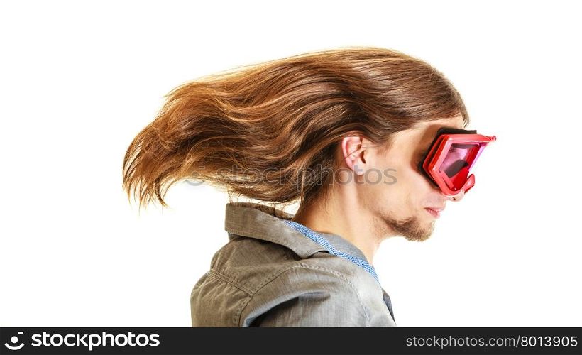 Man in ski glasses goggles. Winter sport.. Man wearing ski glasses goggles. Young guy with long hair flying. Winter sport.