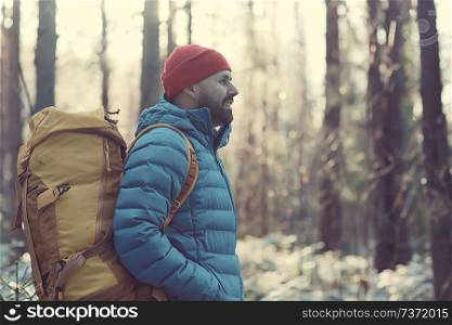 man in sports down jacket landscape winter trekking / down jacket on a tourist, outdoor activities in the north, seasonal landscape