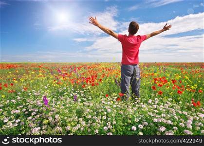 Man in spring meadow of flower. Emotional scene.