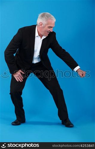 man in suit gesturing on blue background