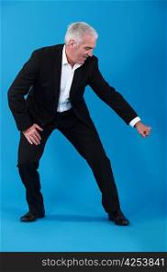 man in suit gesturing on blue background
