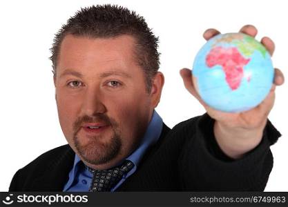 Man in suit holding globe