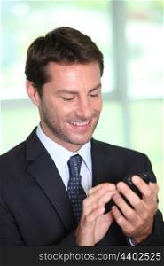 Man in suit looking at mobile