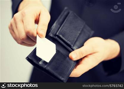 man in suit with wallet and credit card.