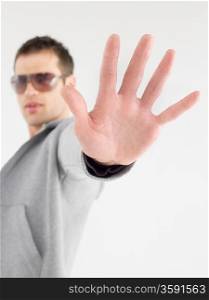 Man in sunglasses viewed past extended hand