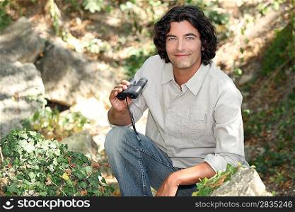 Man in the countryside with binoculars