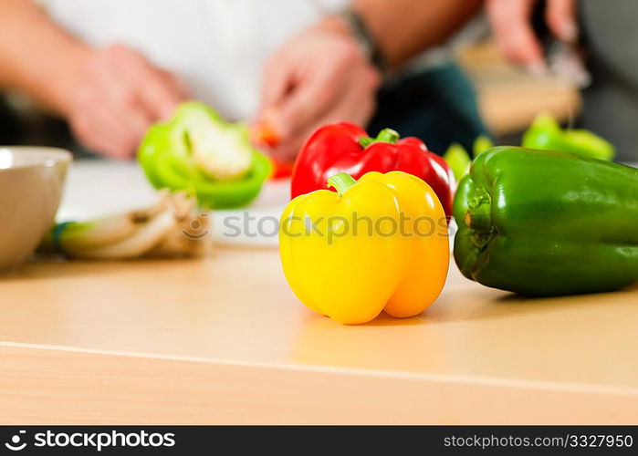 Man in the kitchen ? only hands to be seen ? is preparing the vegetables for dinner or lunch