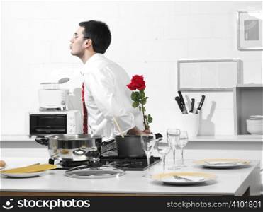 man in the kitchen waiting for his girlfriend with a rose in hand