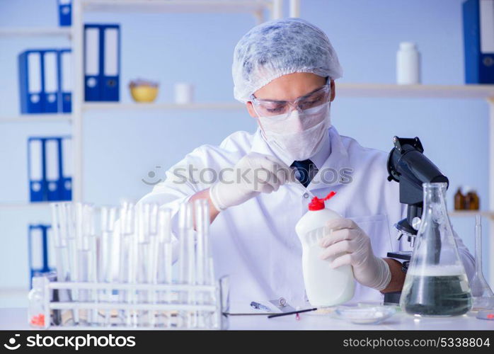 Man in the lab testing new cleaning solution detergent