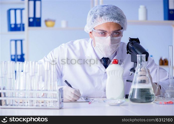 Man in the lab testing new cleaning solution detergent. The man in the lab testing new cleaning solution detergent