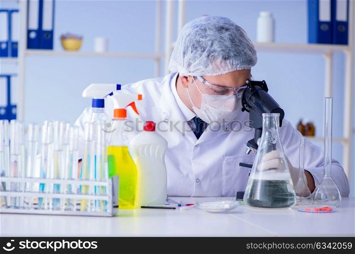 Man in the lab testing new cleaning solution detergent