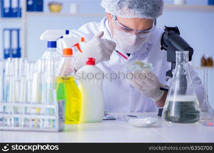 Man in the lab testing new cleaning solution detergent