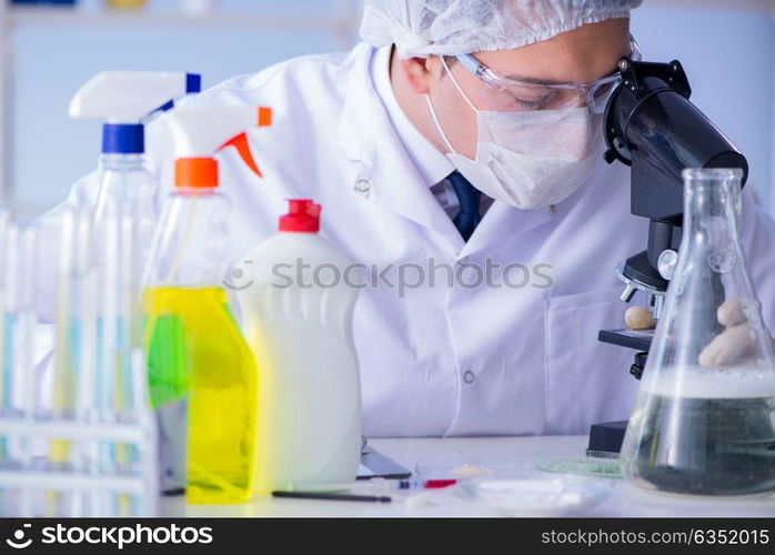 Man in the lab testing new cleaning solution detergent. The man in the lab testing new cleaning solution detergent