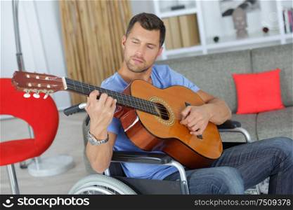 man in the wheelchair playing guitar