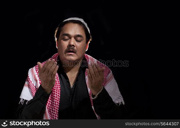 Man in traditional dress praying