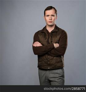 Man in vest isolated on grey background