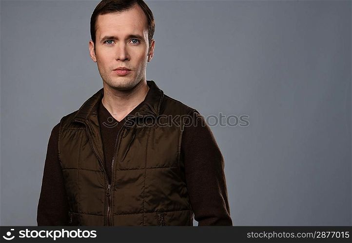 Man in vest isolated on grey background