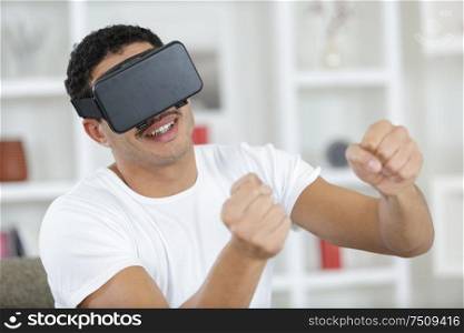 man in vr glasses holding imaginary steering wheel