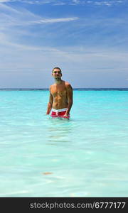 Man in water at tropical beach