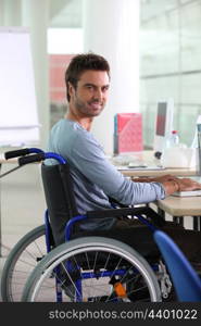 Man in wheelchair working at computer