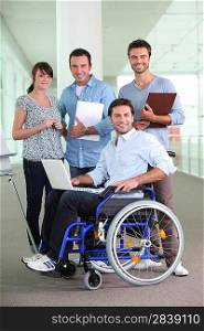 Man in wheelchair working with colleagues