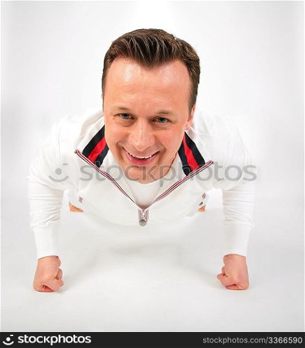 man in white sports suit does exercise
