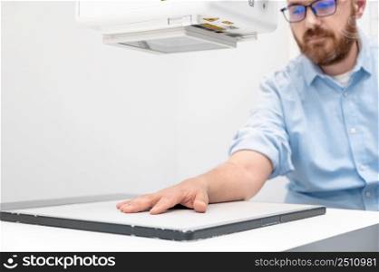 Man in x-ray room having medical scan examination in a modern hospital. High quality photo. Man in x-ray room having medical scan examination in a modern hospital.