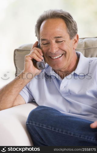 Man indoors using telephone smiling