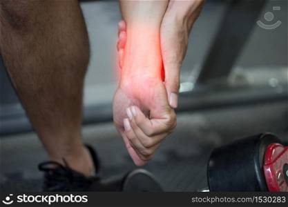 man injury Wrist pain after workout with dumbbell in gym,Healthcare Concept
