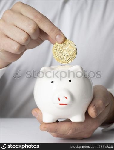 man inserting coin piggy bank
