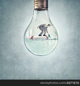 Man inside light bulb. Young businessman floating on life buoy inside of light bulb