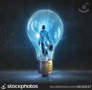 Man inside of electric bulb. Thoughtful businessman inside glass light bulb as brainstorming concept