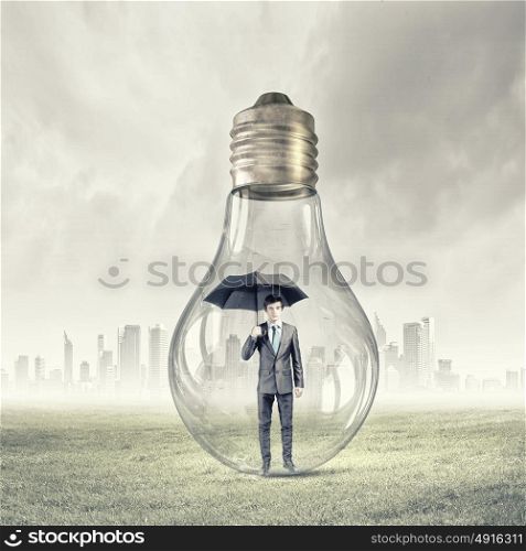 Man inside of glass bulb. Businessman with umbrella and briefcase inside light bulb