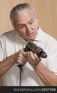 Man inspecting a drill