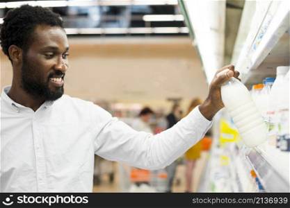 man inspecting bottle milk grocery store