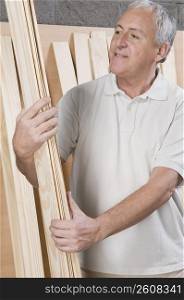 Man inspecting wooden planks