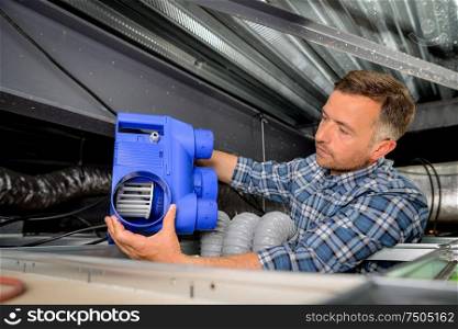 Man installing a new ventilation system