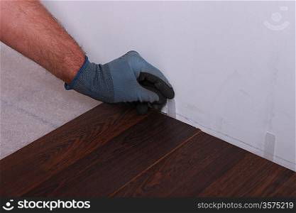 Man installing parquet flooring