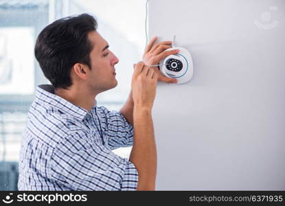 Man installing surveillance CCTV cameras at home