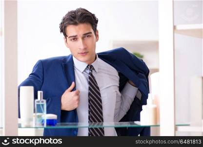 Man is getting dressed up for work in bathroom