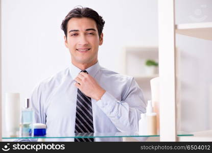 Man is getting dressed up for work in bathroom