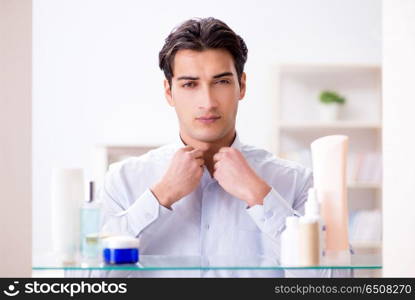 Man is getting dressed up for work in bathroom