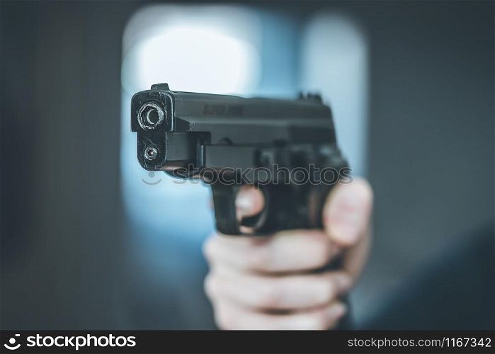 Man is holding a black fire weapon, closeup