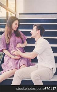 man is listen pregnant of wife, asian handsome father take care mother with couple and expect maternity have a happy, love of family concept.