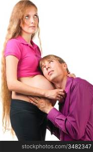 man is listening for baby in stomach of pregnant woman